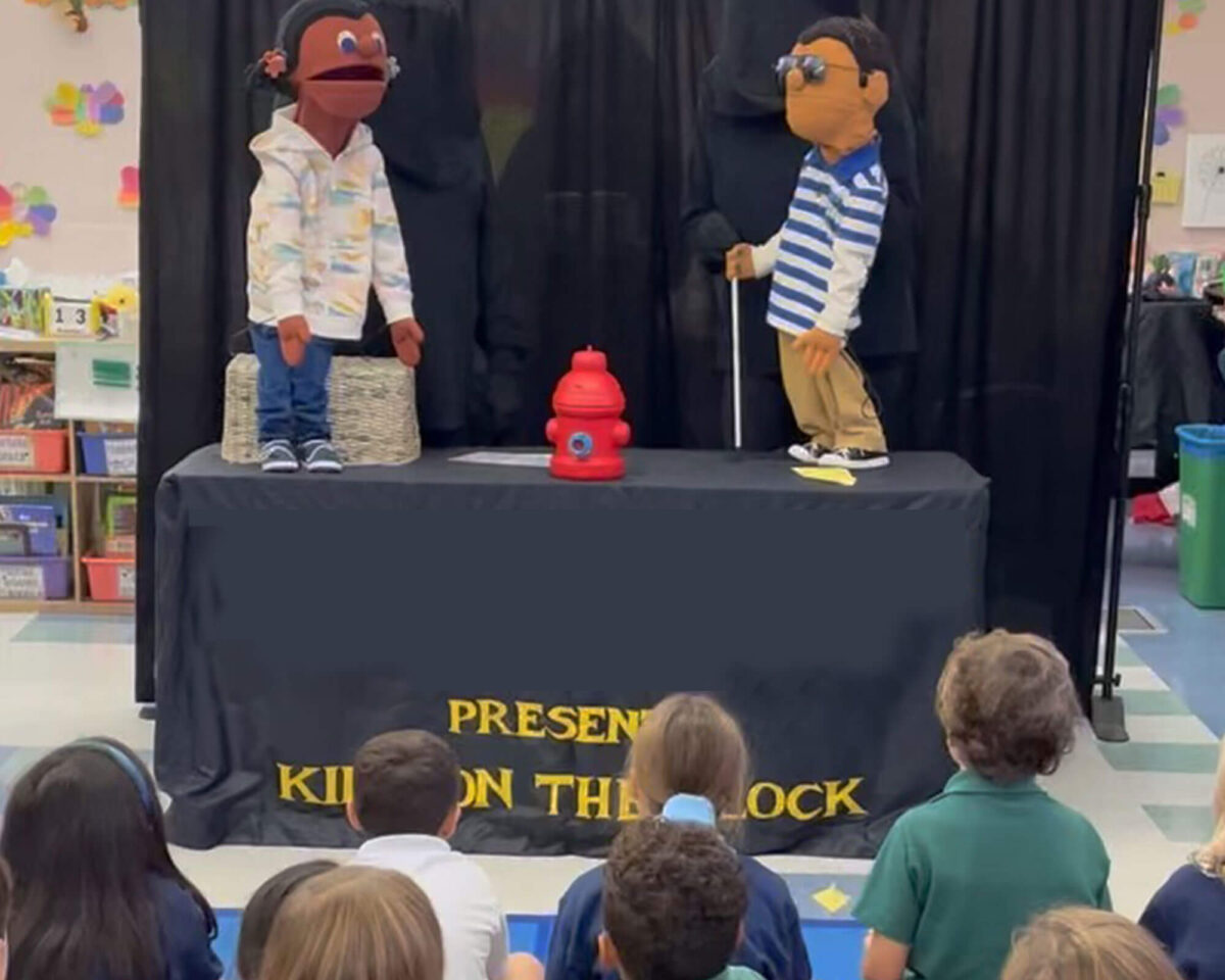 Two puppets performing a Kids on the Block disability awareness show for elementary students