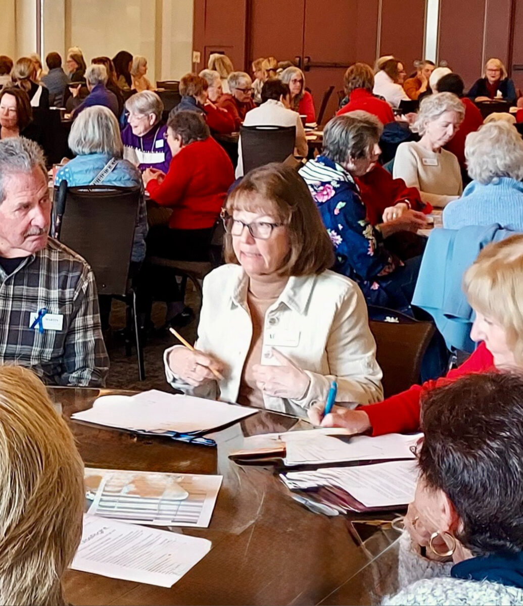 Diablo Valley Giving Partners members reviewing materials together at a large meeting