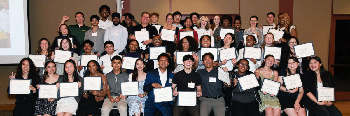 Group of scholarship recipients smiling and holding their award certificates at a Diablo Valley Giving Partners scholarship ceremony